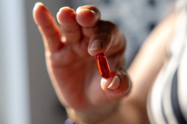 woman holding a red pill