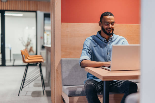 istock Cheerful businessman working on his laptop 2163562225