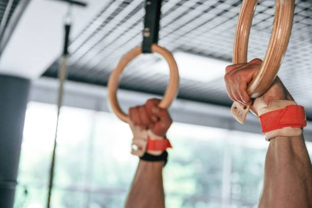 istock Close up view of strong man that is using athlete rings 2163562463