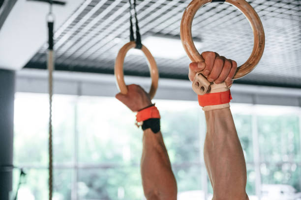 istock Close up view of strong man that is using athlete rings 2163562473