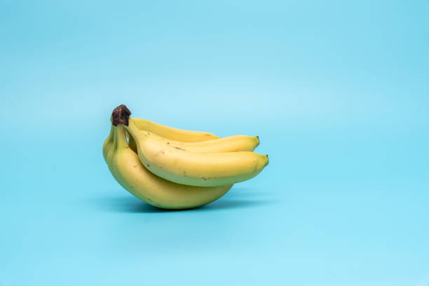 istock Ripe bananas on a blue background. 2163562524