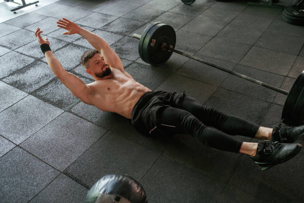 istock Abs exercise. Strong muscular man is working out in the gym 2163564287
