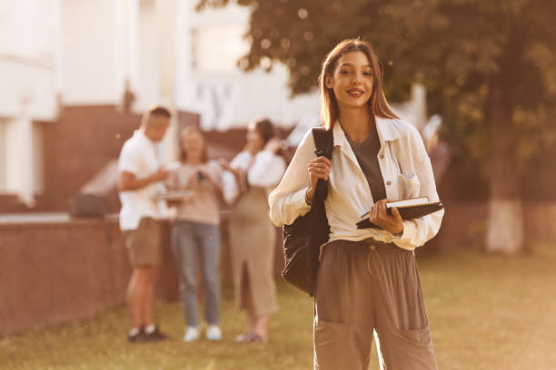 istock Posing, standing. Group of students are outside together 2163564575
