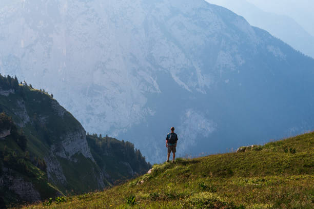 istock Man, tourist with backpack standing above mountain valley. Loser, Austria alps 2163564792