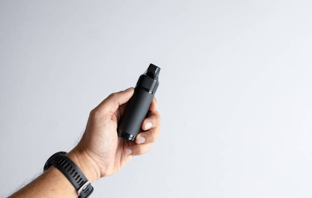 istock Hand Holding Black Vape Device. Pod Kits, Pod Mods, Pod Vapes, electronic cigarettes 2163565462
