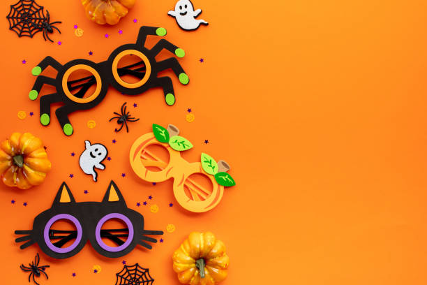 istock Vibrant Halloween decorations on orange backdrop. Perfect for festive designs, invitations, or themed content 2163568483
