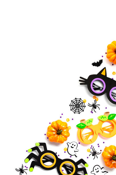 istock Halloween decorations on white background. Top view pumpkins, spiders, webs, spooky glasses. 2163568759