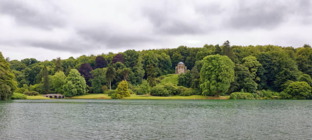 A panoramic view across the lake at Stourhead Warminster Wiltshire UK