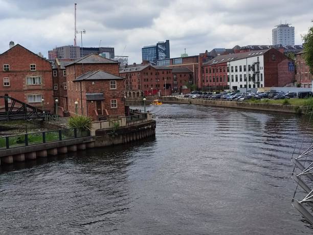 istock Historical buildings by river aire Leeds England UK 2163570800