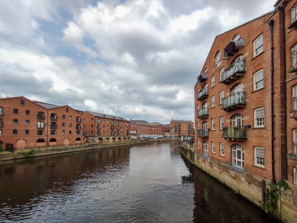 istock Historical buildings by river aire Leeds England UK 2163571156