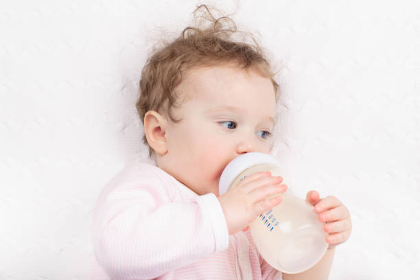 istock Little baby on white bed 2163571177