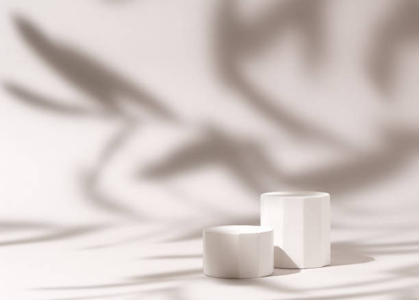 istock Cosmetics product presentation mockup scene made with three white pillars podium stage in leaves shadow. Ideal for showcasing cosmetics, perfumery, jewelry and modern branding visuals. Studio photography. 2163571426