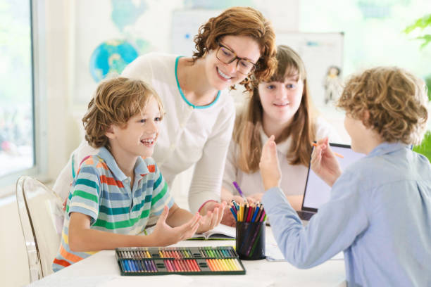 istock Back to school. Kids and teacher in classroom 2163571674