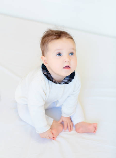 istock Little baby on white bed 2163571686