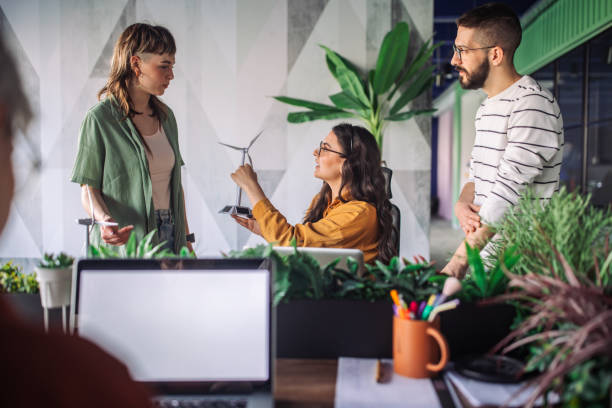 istock Office meeting with wind turbine model and notebook. 2163571840