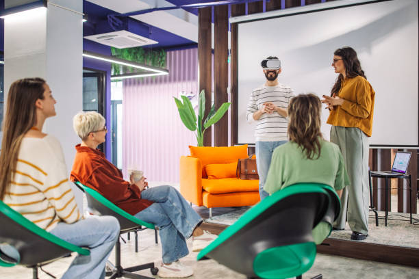 istock Participants engaged in VR demonstration in office 2163572685