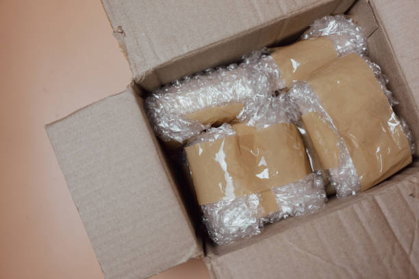 Package wrapped in white bubble pack and brown adhesive tape.