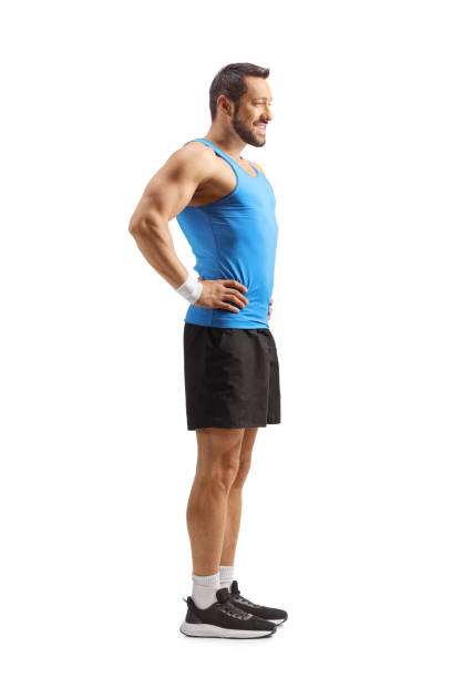 Fit man in sportswear standing and smiling isolated on white background