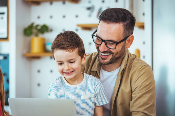 istock Caucasian Father and Son Bonding Over Laptop at Home 2163573826