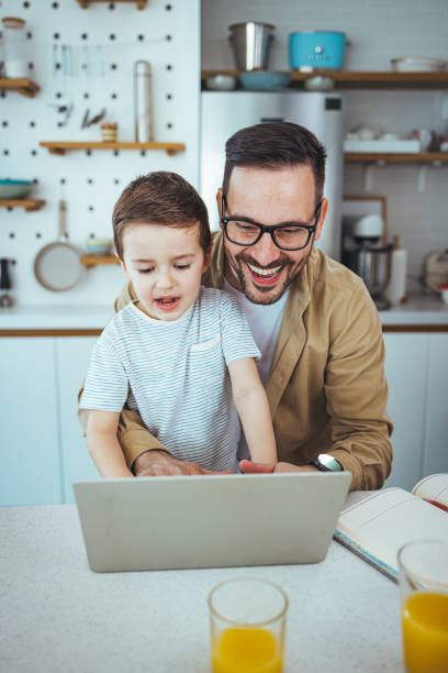 istock Caucasian Dad and Son Sharing a Moment with Technology 2163573928