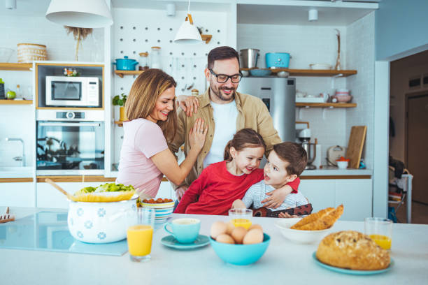 istock Joyful Family Engaging in Breakfast Preparation in Modern Kitchen 2163573929