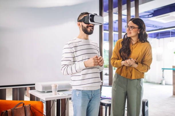 istock Person with VR headset in office explaining technology trends. 2163574322