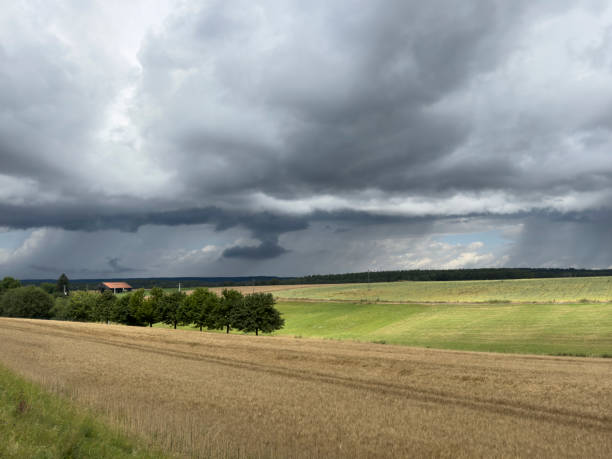 istock dark storm clouds over the field in the landscape 2163575733