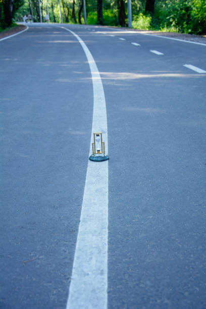 istock Large paved road in the park in spring 2163575843