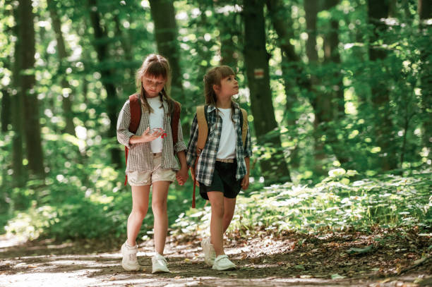 istock Weekend hiking. Kids in forest at summer daytime together 2163576427