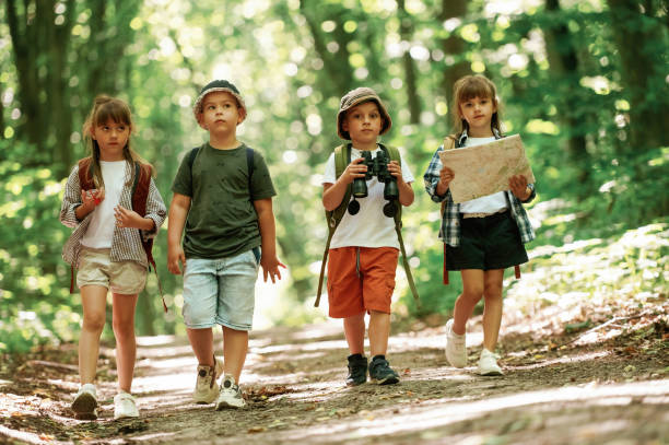 istock Walking together. Kids in forest at summer daytime 2163576445