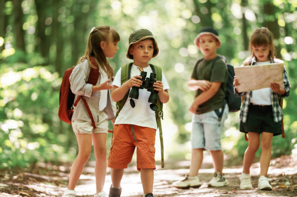 istock Walking together. Kids in forest at summer daytime 2163576458