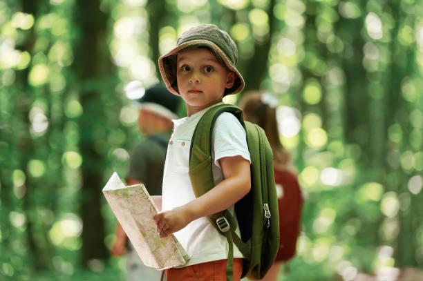 istock Kids in forest at summer daytime together 2163576559