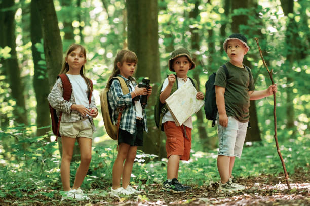 istock Discovering new place. Kids in forest at summer daytime together 2163576568