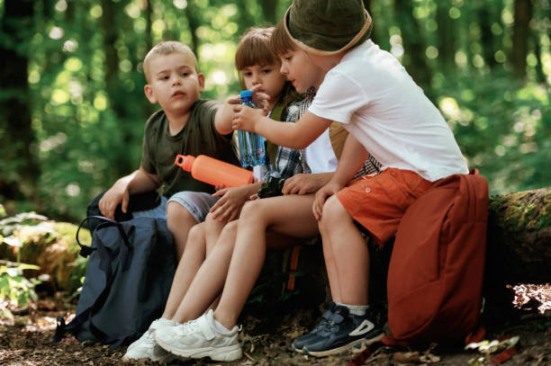 istock Kids in forest at summer daytime together 2163576652