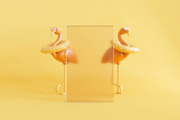 istock Inflatable flamingos behind glass frame on yellow summer background 2163576833