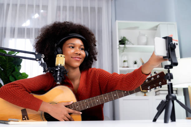 istock Host channel of African setting smartphone in broadcast studio. Tastemaker. 2163578066