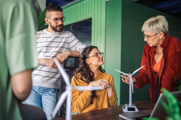 istock Team discussion of wind turbine models in office. 2163578759