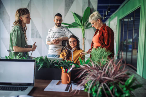 istock Team discussion on eco-friendly project in modern office. 2163578826