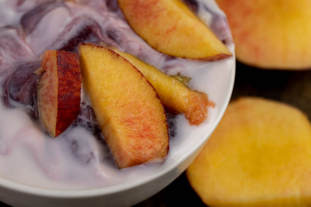 yogurt with jam and pieces of ripe nectarine, natural yogurt in a white bowl