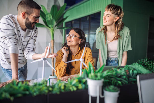 istock Team members brainstorming wind turbine designs together. 2163579783