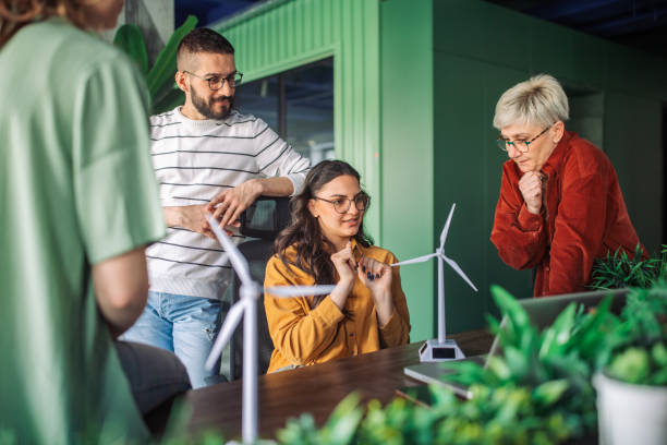 istock Team planning eco-project with wind turbine models. 2163581080