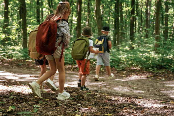 istock Long way, exploring. Kids in forest at summer daytime together 2163581713