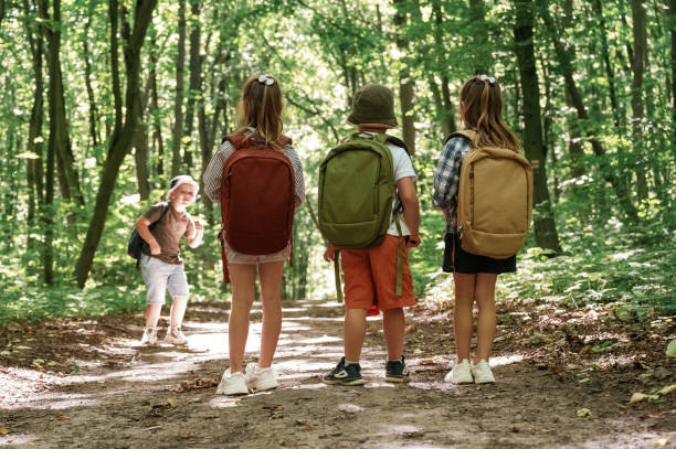 istock Long way, exploring. Kids in forest at summer daytime together 2163581740