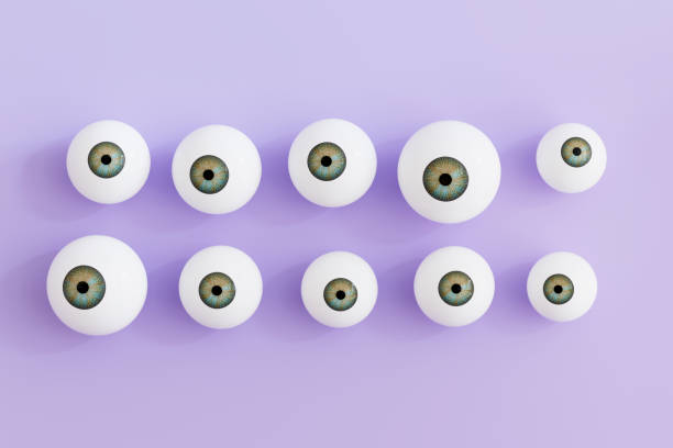 istock Eyeballs, eye iris on lilac background 2163582764