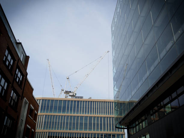 modern architecture in London uk showing tower crane and glass and brick buildings