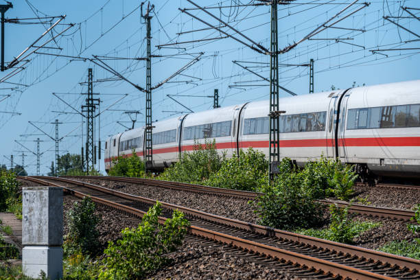 istock Passengertrain with electricity pylons against clear sky 2163585605