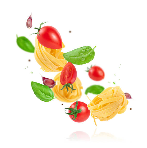 istock Flying tomatoes, pasta, garlic and basil isolated with clipping path. 2163586483