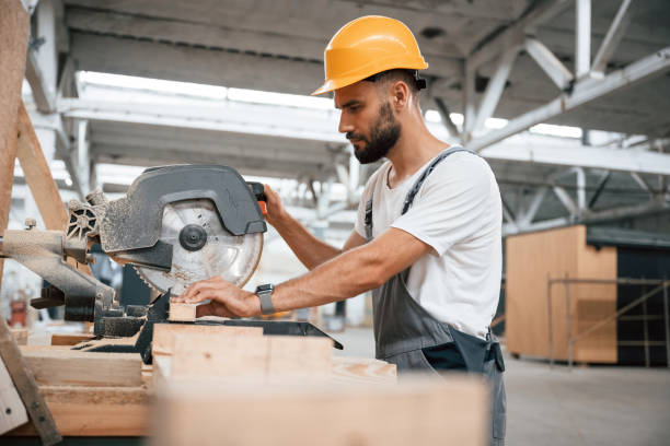 istock Side view, cutting the wood. Industrial worker in the warehouse 2163586596