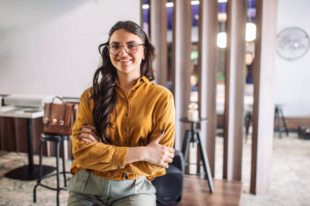 istock Young woman with takeaway cup inside modern office. 2163588280