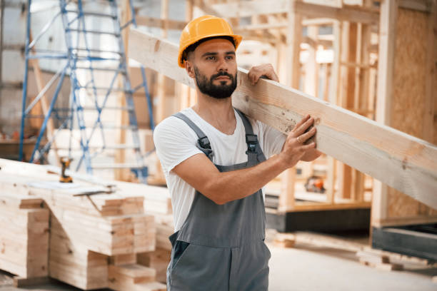 istock Front view, holding plank. Industrial worker in wooden warehouse 2163588482